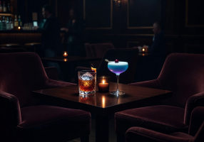 Cocktails at a private table in a dark lounge